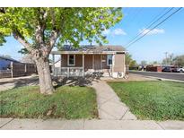 Charming single-story home with a well-maintained lawn and inviting front porch at 391 N 7Th Ave, Brighton, CO 80601