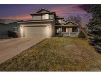 Inviting two-story home with a two-car garage, brick accents, and a cozy front porch at 13451 Clermont St, Thornton, CO 80241