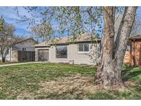 Charming single-story home with a gray brick exterior, well-manicured lawn, and attached garage at 3075 Fairfax St, Denver, CO 80207