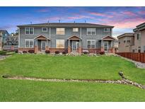 Inviting multi-Gathering exterior with manicured lawn, brick accents, and beautiful landscaping at 8237 W 54Th Ave # 2, Arvada, CO 80002
