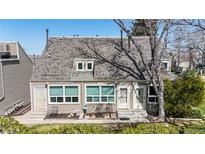 Inviting two-story home featuring manicured landscaping and a cozy front entrance with seating area at 381 S Estes St # 1, Lakewood, CO 80226