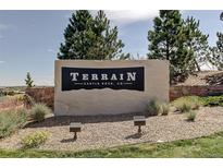 Terrain community sign featuring manicured landscaping and stone details in Castle Rock, Colorado at 4371 Soapberry Pl, Castle Rock, CO 80108