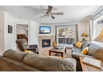 Inviting living room with a fireplace, comfortable seating, and access to an outdoor patio at 283 Pelican Cir # 1703, Breckenridge, CO 80424