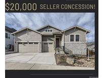 Inviting home featuring a three-car garage, stone accents, and well-maintained landscaping at 2905 Morningbird Ln, Castle Rock, CO 80109