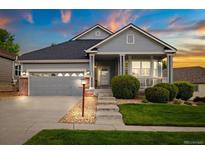 Charming single-Gathering home featuring a covered front porch, well-kept lawn, and attached two-car garage at 22166 E Chestnut Pl, Aurora, CO 80016