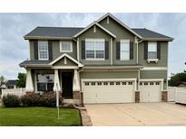 Inviting two-story home featuring a well-maintained lawn, attached two car garage, and lovely curb appeal at 5861 Mt Shadows Blvd, Firestone, CO 80504
