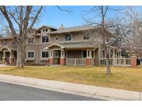 Charming multi-story home featuring a covered porch, well-maintained lawn, and inviting curb appeal at 275 Pontiac St, Denver, CO 80220