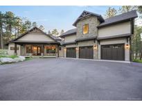 Stunning stone and stucco home with an oversized driveway and three-car garage at 18330 Archers Dr, Monument, CO 80132
