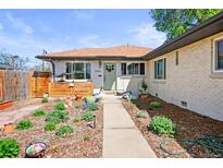 Charming single-story home featuring a landscaped front yard, walkway, and inviting entrance at 3450 N Harrison St, Denver, CO 80205