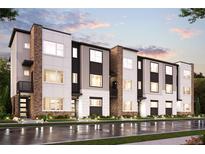 Modern three-story townhomes with brick and light-colored siding, showcasing a sleek design at 457 Interlocken Blvd # 102, Broomfield, CO 80021