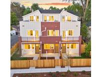 New construction townhome with fenced yards and shared balcony space at 1048 Knox Ct, Denver, CO 80204
