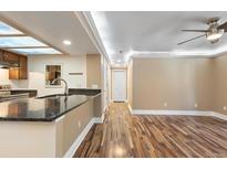Bright living room featuring wood floors, neutral walls, and a ceiling fan at 10890 W Evans Ave # 1G, Lakewood, CO 80227