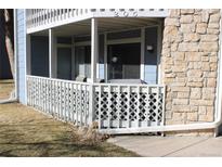 Comfortable covered porch with white railing, perfect for relaxing outdoors at 8600 E Alameda Ave # 105, Denver, CO 80247