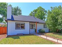 Charming single-Gathering home boasts a well-maintained lawn, updated windows, and inviting walkway with landscape lighting at 2337 S Franklin St, Denver, CO 80210