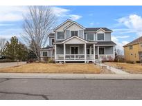 Charming two-story home with a welcoming front porch and well-maintained lawn at 3063 E 148Th Pl, Thornton, CO 80602