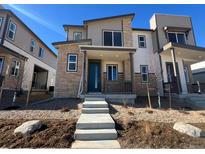 Modern two-story home with a stone facade and a welcoming front porch at 6591 N Netherland St, Aurora, CO 80019