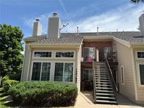 Inviting exterior showcasing a two-story condo with brick accents, large windows, and well-maintained landscaping at 13762 E Lehigh Ave # B, Aurora, CO 80014