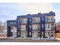 Modern apartment building with black metal and stone facade, featuring balconies and street access at 5128 W 26Th Ave # 208, Denver, CO 80212