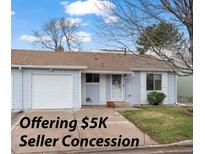 Charming single-story home with light blue siding, attached garage and well-maintained front yard at 16120 E Radcliff Pl, Aurora, CO 80015