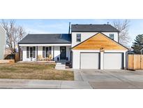 Updated two-story home with a modern facade, two-car garage, and inviting front porch at 12293 W Saratoga Ave, Morrison, CO 80465