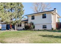 Charming two-story home with a well-maintained lawn and mature trees, perfect for suburban living at 6071 S Ingalls St, Littleton, CO 80123