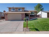 Charming two-story home features a well-maintained front yard and attached two-car garage at 9700 W 88Th Pl, Westminster, CO 80021