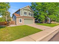 Charming two-story home with a well-maintained lawn and an attached two car garage at 14712 Josephine St, Thornton, CO 80602