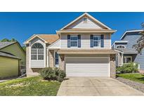 Charming two-story home with brick accents, blue shutters, and a well-maintained front yard at 13069 Jackson Dr, Thornton, CO 80241