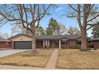 Charming brick ranch-style home featuring mature trees and a well-maintained front yard at 2448 S Krameria St, Denver, CO 80222
