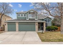 Charming two-story home featuring a three-car garage and a well-maintained front yard at 5758 S Jasper Way, Centennial, CO 80015