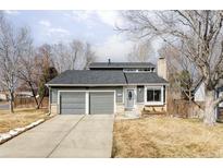 Charming home featuring a well-maintained lawn, two-car garage, and inviting front entrance at 10985 W Alamo Pl, Littleton, CO 80127