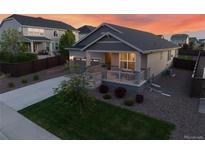 Charming home featuring landscaped front yard, inviting porch and an attached two-car garage at 14431 Forest St, Thornton, CO 80602