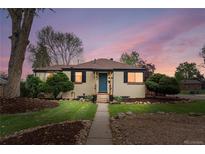 Charming home with a well-manicured lawn, rock landscaping, and inviting front entrance at 3000 N Fillmore St, Denver, CO 80205