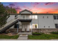 Inviting townhome exterior with stairway to the 2nd story entrance and well-maintained front lawn at 18038 Becket Dr, Parker, CO 80134