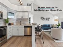 Well-lit kitchen showcasing stainless steel appliances and white cabinets at 11195 Alcott St # D, Westminster, CO 80234
