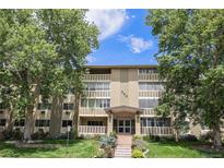 Attractive building exterior with a manicured lawn, mature trees and welcoming entrance at 350 S Clinton St # 2A, Denver, CO 80247