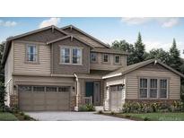 Charming two-story home with siding and stone accents, attached two and one car garages, and a landscaped yard at 14573 Hudson Way, Thornton, CO 80602