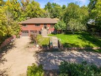 Charming brick home featuring an attached garage and a well-maintained front yard at 1196 S Quebec Way, Denver, CO 80231