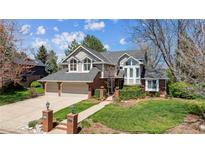 Charming two-story home boasts a manicured lawn, two-car garage, and brick accents at 3 Winged Foot Way, Littleton, CO 80123