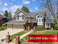 Charming two-story home featuring a brick facade, manicured lawn, and a spacious two-car garage at 3 Winged Foot Way, Littleton, CO 80123