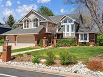 Charming home with a two-car garage, beautiful front lawn, and blooming plants at 3 Winged Foot Way, Littleton, CO 80123