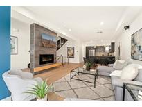 Open living room showcasing a modern fireplace and stylish furniture at 1555 Perry St, Denver, CO 80204