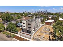 New construction showing a contemporary three-story townhome and the community's developing landscape with city views at 1372 Lowell Blvd # 2, Denver, CO 80204