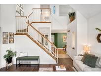 Spacious living room features a cozy fireplace and hardwood floors at 8117 W 90Th Dr, Westminster, CO 80021