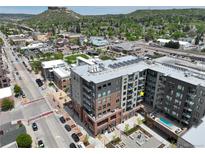 Stunning aerial view of the modern condo building close to the city with mountain views at 20 Wilcox St # 517, Castle Rock, CO 80104