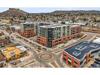 View of new apartment buildings in a walkable neighborhood near mature trees and mountains at 20 Wilcox St # 517, Castle Rock, CO 80104