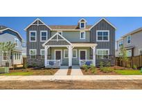 Charming townhome featuring well-maintained landscaping, dual front doors, and a modern design with stone and siding accents at 15238 Detroit St, Thornton, CO 80602