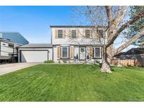 Charming two-story home featuring a well-manicured lawn and eye-catching wood shutters at 4733 S Vivian Ct, Morrison, CO 80465