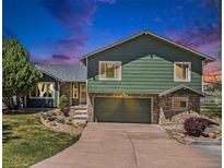 Charming two-story home with a stone-accented facade, attached garage, and beautifully landscaped front yard at 7701 Hillgate Way, Parker, CO 80134