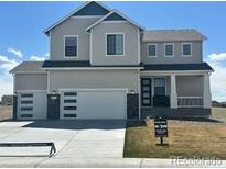 Beautiful two story home features a three car garage, modern design, and manicured lawn at 42984 Colonial Trl, Elizabeth, CO 80107